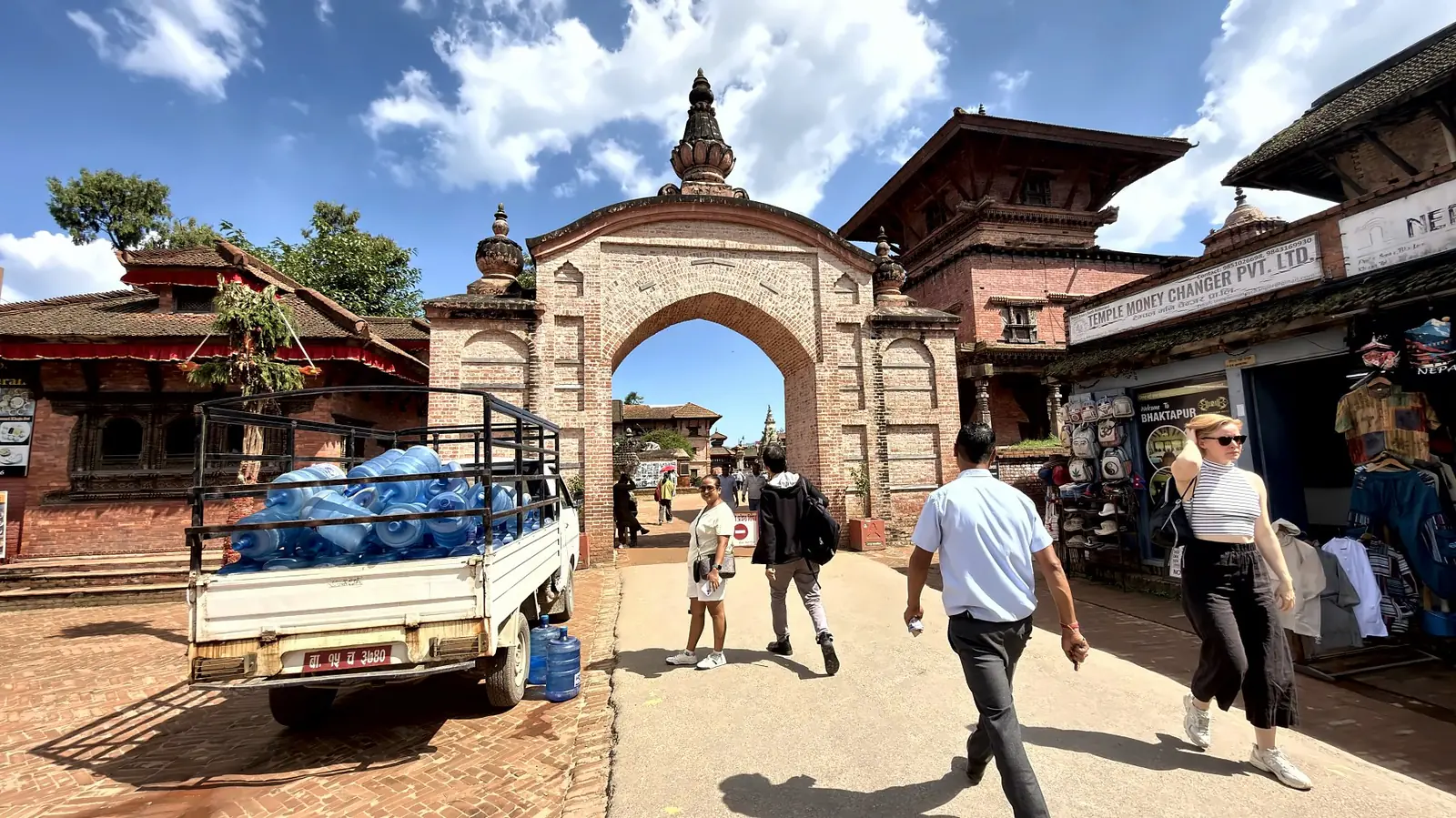 Brick arched gateway into Bhaktapur old town with visitors walking through